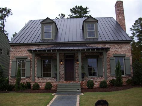 red brick house with brown metal roof|red brick homes with siding.